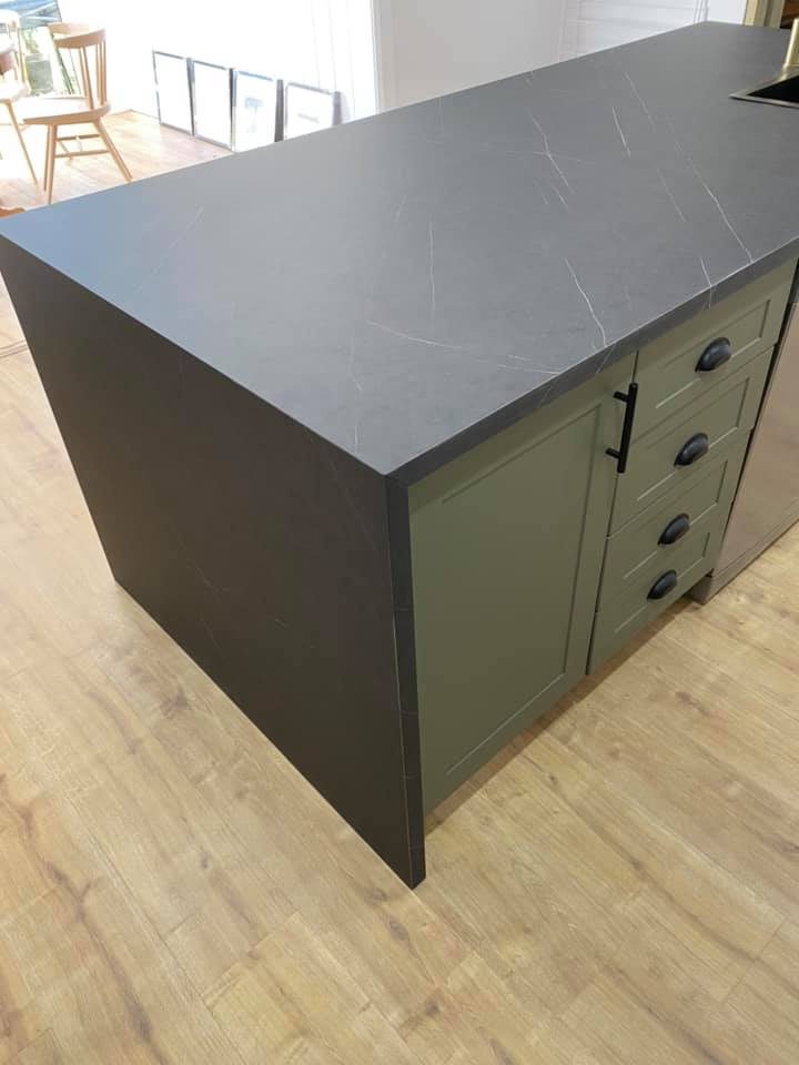 Sage green shaker island with charcoal stone benchtop