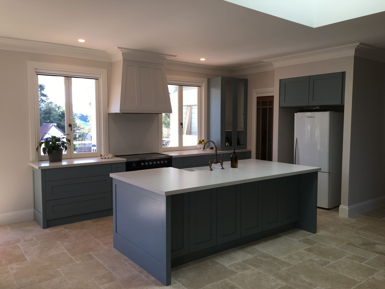 Warm timber and white kitchen with stone benchtops and subway tile splashback