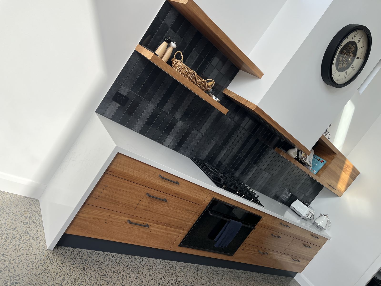 Custom kitchen with timber servery bench, dark splashback and open shelving