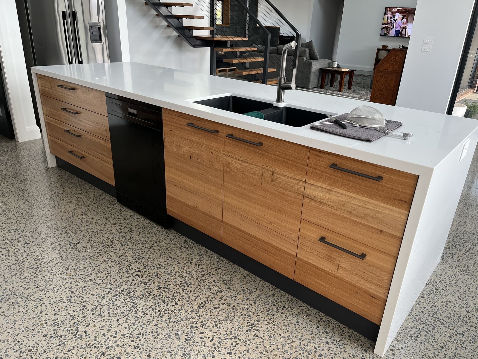 Two-tone kitchen with timber and white cabinetry and integrated dishwasher