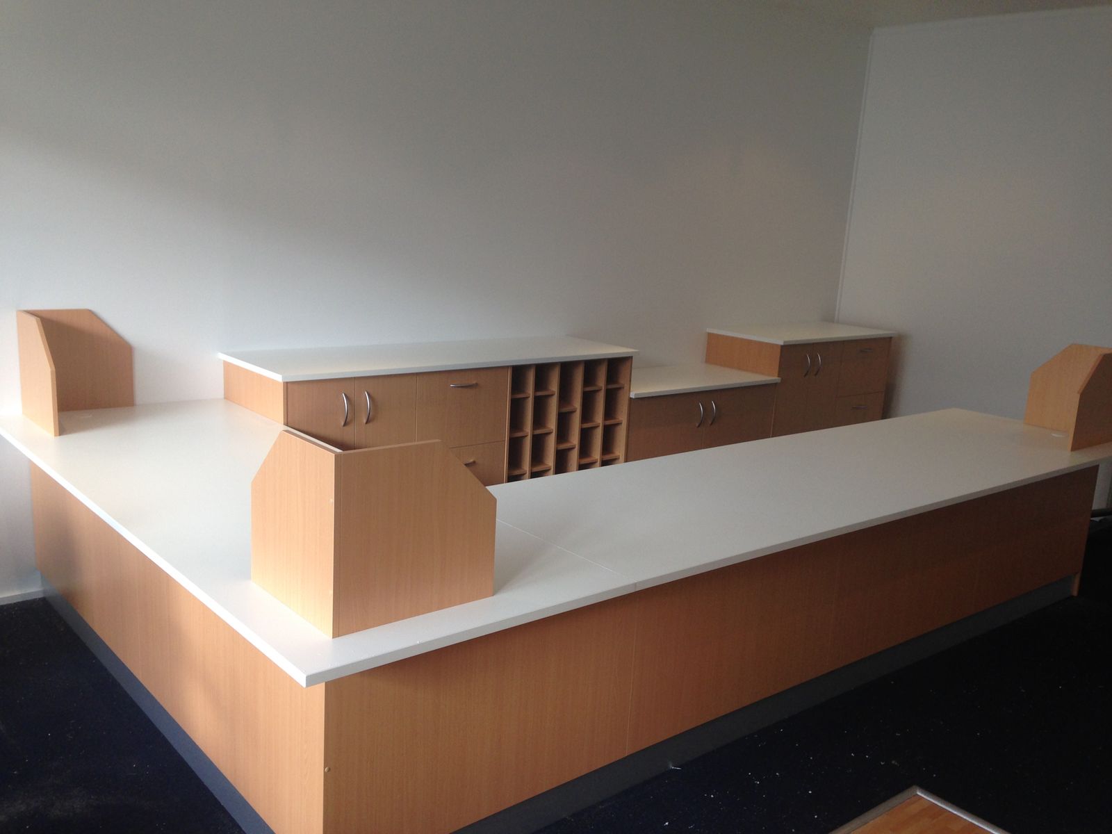 Reception desk with warm timber front and white stone counter