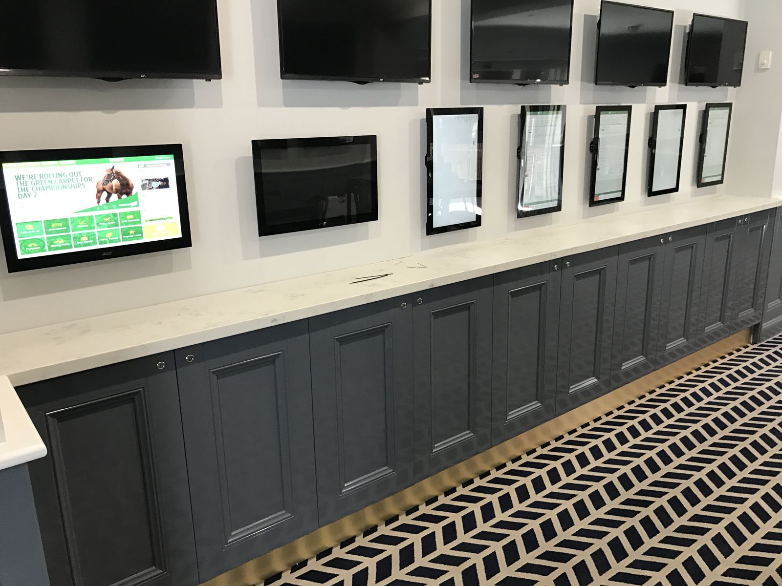 Commercial venue wall joinery with mounted screens and gaming displays