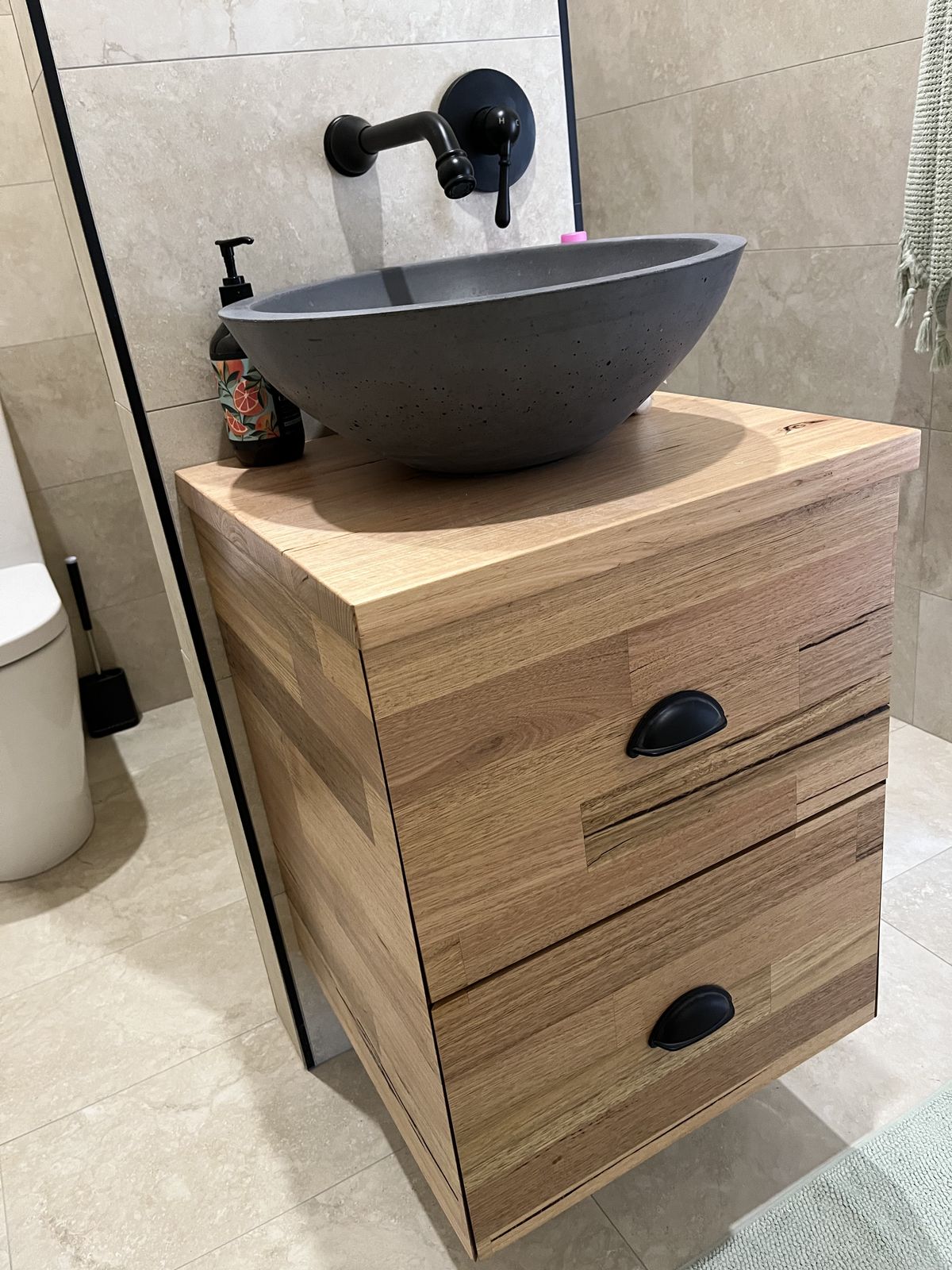 Floating timber vanity with white stone benchtop and undermount basin