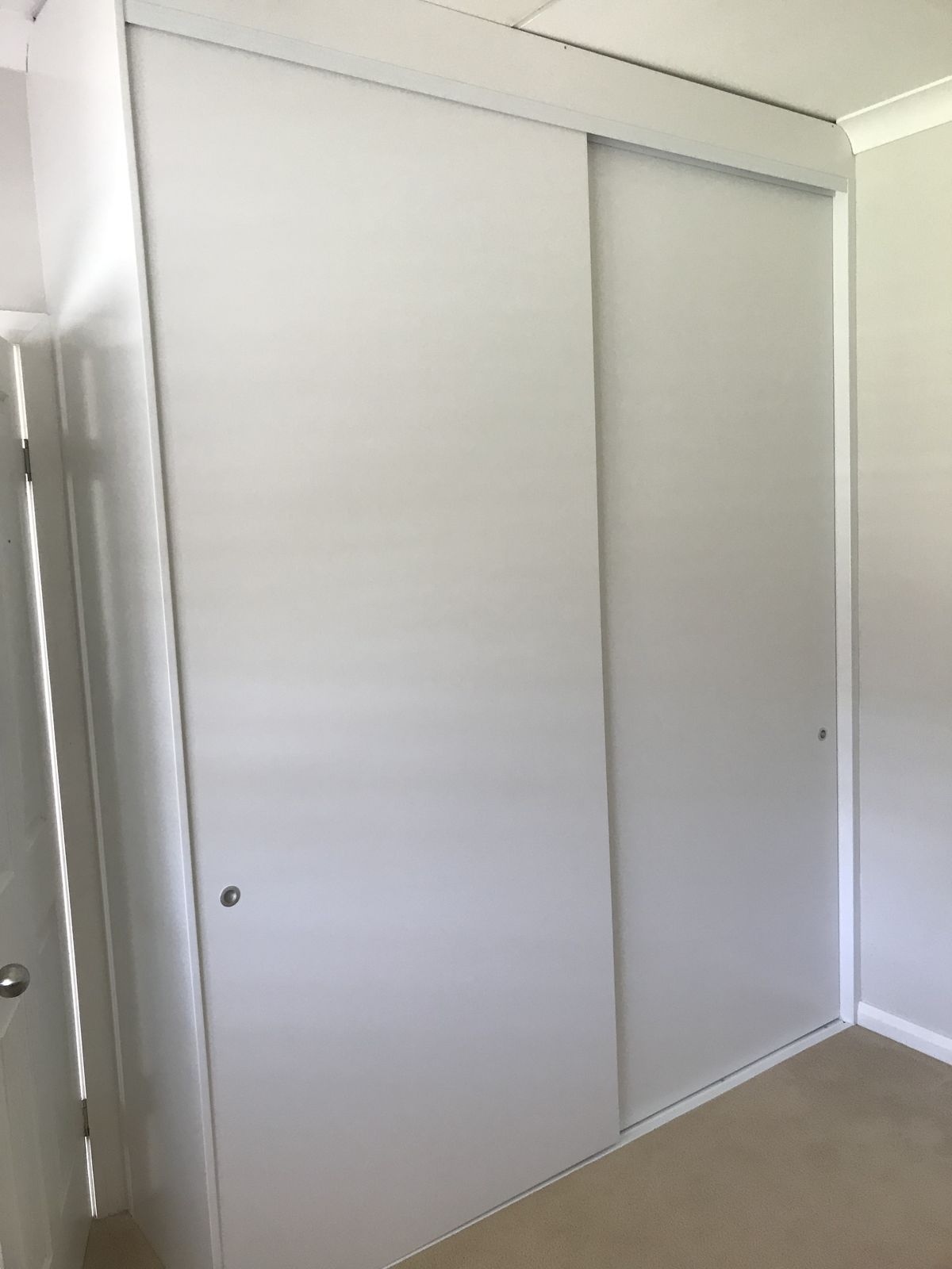 Custom walk-in wardrobe interior with shelving, drawers and hanging space